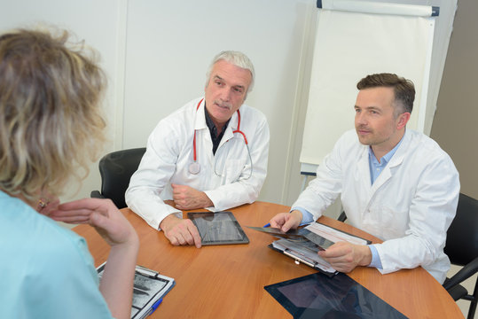 group of doctors meeting and taking notes at medical office