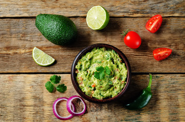 Guacamole with flying corn chips and ingredients to prepare it - obrazy, fototapety, plakaty