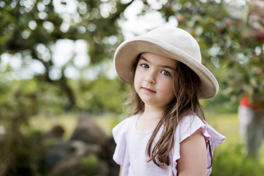 Portrait Of Cute Girl Wearing Hat Standing At Park