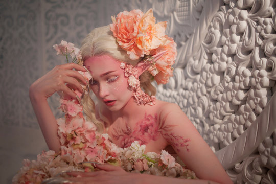 lovely she-elf among flowers. Creative make-up and bodyart