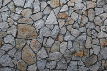 Old granite stone wall texture background close up,