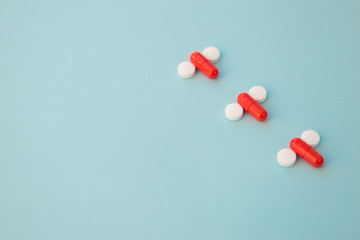 penis symbol made out of medical red capsules and white tablets 