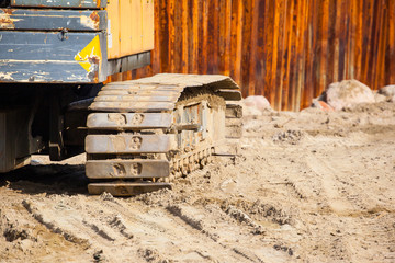 caterpillar excavator on the sand of the construction site