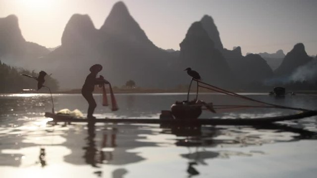 Cormorant fisherman on sunset