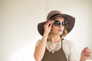 girl in hat with sunglasses serious