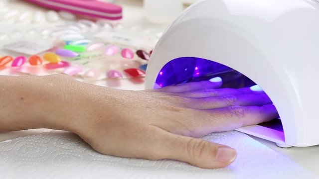 Manicure with led lamp in process