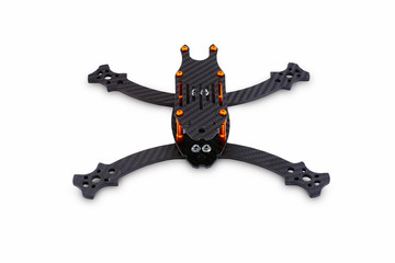 The beginning of the racing drone assembly. A robust frame of an unmanned aerial vehicle made of carbon fiber. Frame of carbon fiber quadrocopter isolated on white background
