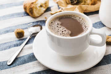 Cappuccino on a striped tablecloth. Morning coffee.