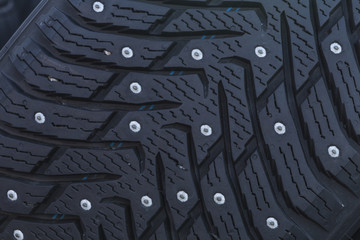 Close-up of a studded tire with spikes for winter driving