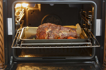 Baked meat, tomatoes and rosemary in the oven