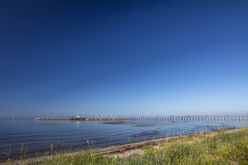 Deep blue sky and blue waters of Semiahmoo Bay meet at pier.
