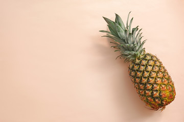 Fresh ripe pineapple on color background, top view