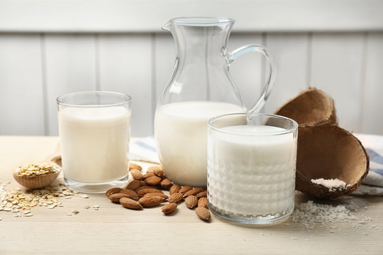 Composition with different types of milk on wooden table
