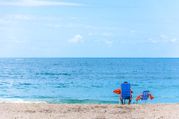 Fototapeta na wymiar chair, umbrella and person on the beach.