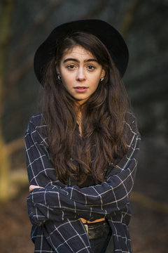 Portrait of woman with arms crossed standing in Epping Forest