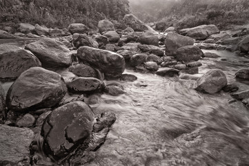 River water flowing through rocks at dawn