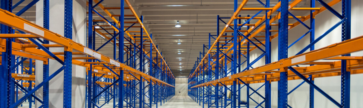 Wide image of empty shelves in logistics warehouse