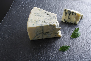 blue cheese on a stone background black