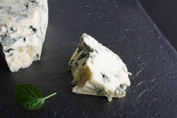 blue cheese on a stone background black