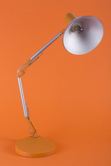 Table lamp for desktop on an orange background