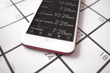 A calendar and World time mobile phone app are used for travel planning 