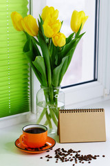Yellow tulips and cup of coffee