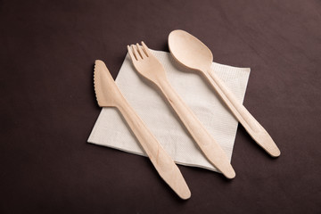 wooden tableware with tissue on table