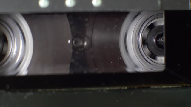 Close up of an audio cassette tape rewinding