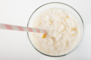 Healthy eating,diet smoothie drink is made from natural  pear and banana with a straw on a white wooden background