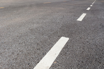 Asphalt road with marking lines white stripes texture Background.