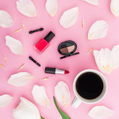 Obraz na płótnie Canvas Beauty composition with tulips flowers, coffee mug and cosmetics on pink background. Top view. Flat lay. Home feminine desk.