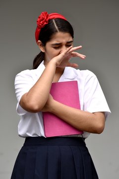Tearful Catholic Person Wearing School Uniform With Notebook
