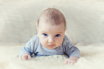 cute baby with blue eyes crawling forward