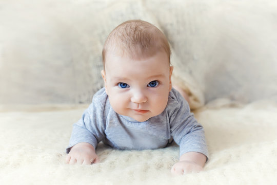cute baby with blue eyes crawling forward