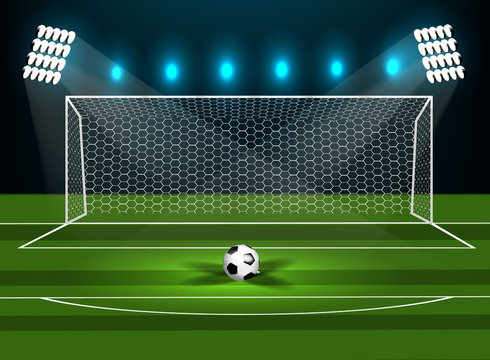 Football goal on a green field with a football.