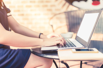 Naklejka premium Business female working with laptop coffee and smart phone on office outdoor.