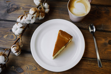 Fancy caramel cheesecake on table flat lay