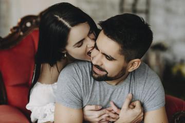 Young couple sitting on armchair and enjoying themselves.