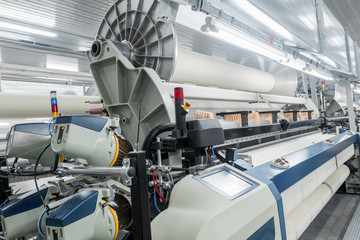 Machinery and equipment in the weaving shop, detailed review. interior of industrial textile factory. loom