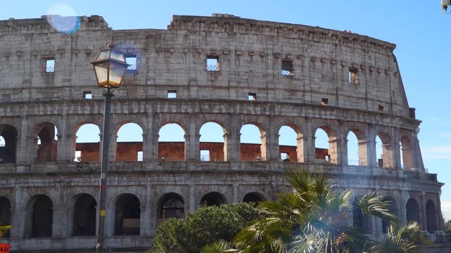 The Coliseum of Rome against the blue sky. Natural light patches