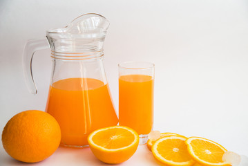Naklejka na ściany i meble Freshly squeezed orange juice and a glass beaker. Composition of freshly squeezed orange juice and orange slices
