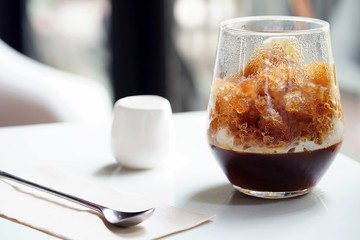 A special iced coffee menu served with coffee jelly in bottom and topped with crushed freezing milk in first layer and then topped with crushed freezing coffee.A good refreshing menu with copy space.