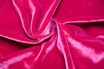 Obraz premium Background of fabric, twisted folds on red velvet.