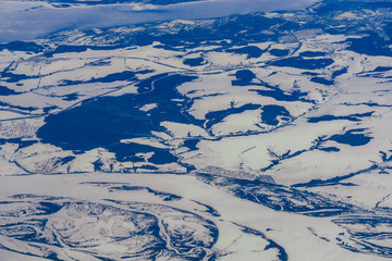 aerial photography from a plane of lakes and rivers in Russia in Siberia in the snow
