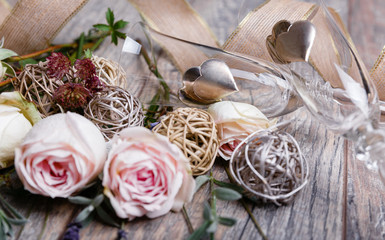Festive close up flower pink English rose, lavender composition, glasses of champagne, silver heart on wooden background. Overhead top view, flat lay. Copy space. Valentines, Wedding Day concept.