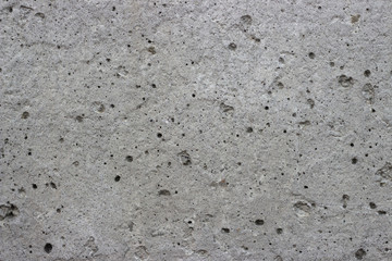 Gray wall of concrete with pores, textures, background.