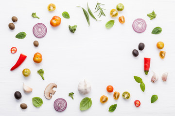 Various fresh vegetables and herbs on white background.Ingredients for cooking concept sweet basil ,tomato ,garlic ,pepper and onion with flat lay..