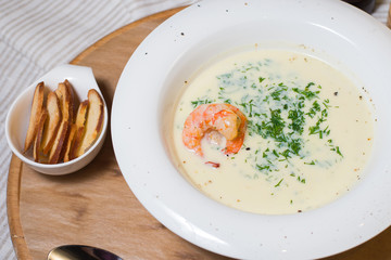 Soup Cream Shrimp on a White Plate on a Tree