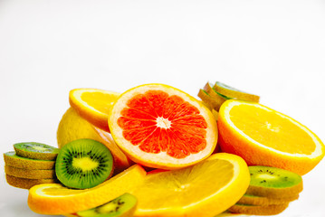 Exotic fruits on a white background. Grapefruit, orange, lemon, lime and kiwi