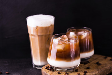 Iced coffee in glasses with milk. Black background